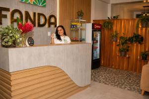 a woman sitting at a counter in a store at Fanda in Sauce