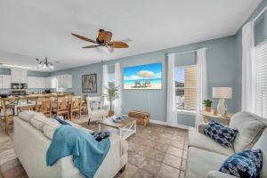 a living room with a couch and a dining room at Dandy Sandy Sleeps 24 - Pets - Pools - Hot Tubs in Gulf Shores