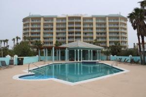 a swimming pool in front of a large building at Dandy Sandy Sleeps 24 - Pets - Pools - Hot Tubs in Gulf Shores