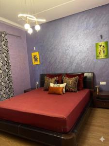 a bedroom with a large bed with red sheets at Luxury apartment Smir Park - Marina Smir in Marina Smir