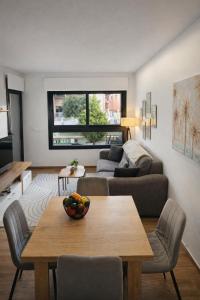 a living room with a table and a couch at Private Garden Apartment - Villamartin, Orihuela Costa in Villamartin