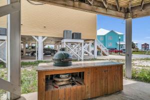 a building with a table with a helmet on top at Dandy Sandy Sleeps 24 - Pets - Pools - Hot Tubs in Gulf Shores +136 photos