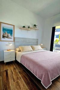 a bedroom with a large bed and a window at Private Garden Apartment - Villamartin, Orihuela Costa in Villamartin