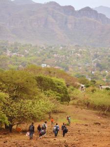 a group of people walking down a dirt road at Domo Geodésico en Malinalco in Malinalco +3 photos