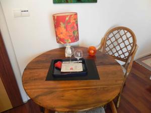 a table with a plate of food and a wine glass at Au Coeur Du Vignoble in Orschwiller