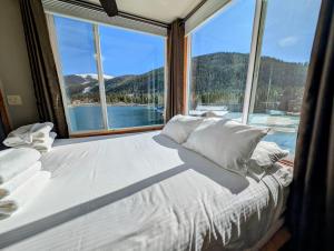 a large bed in a room with a large window at Lakeside 1485 by SummitCove Lodging in Colorado in Keystone