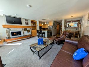 a living room with a couch and a fireplace at Lakeside 1485 by SummitCove Lodging in Colorado in Keystone +35 photos