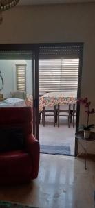 a living room with a bed and a couch and a table at Ville n4 in Sidi Daoud