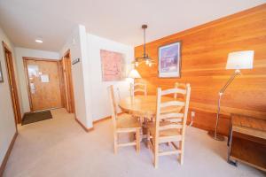 a dining room with a wooden table and chairs at Lakeside 1495 by SummitCove Lodging in Colorado in Keystone