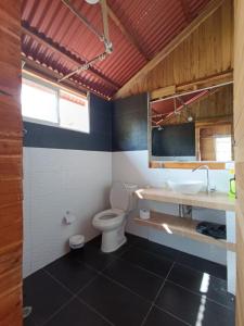 a bathroom with a toilet and a sink at Palmar Beach Cabañas - Bahía Rada in Moñitos