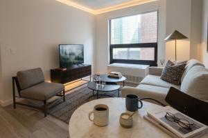 a living room with a couch and a table at Court Square Hotel Long Island City New York , Belvilla District 6 Formerly Sonder in Long Island City