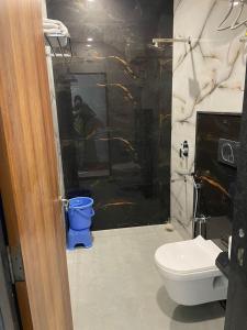 a bathroom with a toilet and a glass shower at Hotel jbs inn in Jaipur