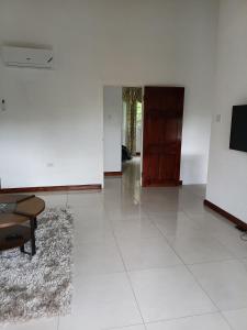 a living room with a couch and a tv on a wall at Gorgeous One Bedroom Apartment in Kingston