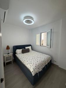 a bedroom with a bed and a window at Galia costa ballena 2 in Cádiz