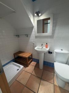 a bathroom with a toilet and a sink at Galia costa ballena 2 in Cádiz +14 photos