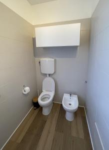 a small bathroom with a toilet and a sink at A casa di Any in Cascina +10 photos