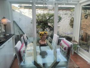 a glass table with a bust of a woman sitting on it at Lavender Cottage in Yarm