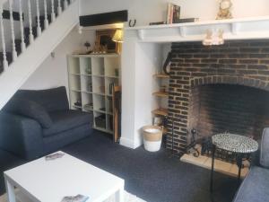 a living room with a couch and a fireplace at Lavender Cottage in Yarm