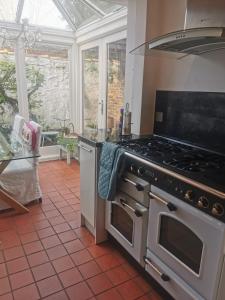 a kitchen with an oven and a stove top at Lavender Cottage in Yarm +9 photos
