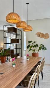 a dining room with a wooden table and chairs at Hotel Roma in São Sebastião