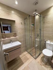 a bathroom with a shower and a toilet and a sink at Casa de Marinero in Martil +50 photos