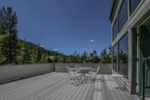 a patio with a table and chairs on a deck at Keystone Bristlecone Home 31 by SummitCove Lodging in Colorado in Keystone