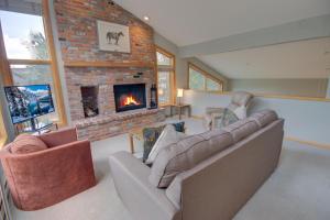 a living room with a couch and a fireplace at Keystone Bristlecone Home 31 by SummitCove Lodging in Colorado in Keystone