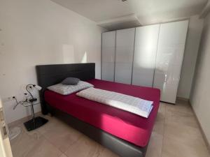 a bedroom with a black and red bed with a lamp at Moderne Wohnung mit Stil in Grossgerungs