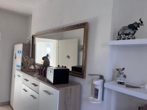 a room with a mirror and a counter with a microwave at Moderne Wohnung mit Stil in Grossgerungs +38 photos