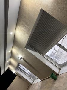 a ceiling with a window in a room at Appartement vue mer 200m in Rejiche +32 photos