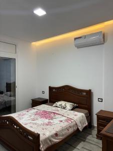 a bedroom with a bed and a air conditioner at Appartement vue mer 200m in Rejiche