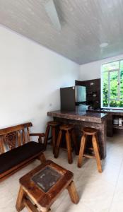 a kitchen with a table and some wooden stools at Hotel villa dulce campestre in Melgar