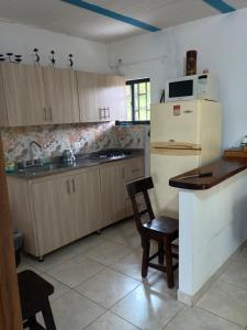 a kitchen with a refrigerator and a table and chairs at PUEBlA in Marinilla