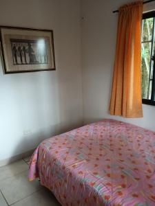 a bedroom with a bed and a window at PUEBlA in Marinilla