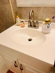 a bathroom sink with a white counter top at Bankston A in Marietta +10 photos
