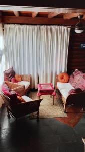 a living room with two chairs and a couch at Casita de Belén in Merlo