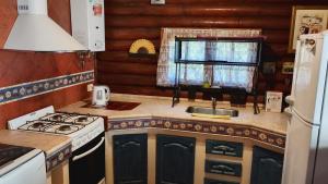 a small kitchen with a stove and a sink at Casita de Belén in Merlo
