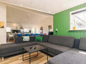 a living room with a couch and a green wall at 4 star holiday home in Vinderup in Vinderup