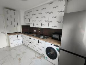 a kitchen with lots of writing on the wall at Cubo Rooms Olhão in Olhão