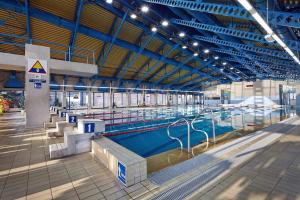 a large indoor swimming pool in a building at Hotel Włókniarz in Pabianice