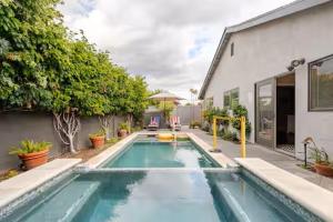 a swimming pool in front of a house at Amazing days Spa Pool Villa near Disney & Beaches in Placentia