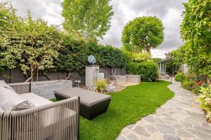 a garden with a bench and a table and grass at Amazing days Spa Pool Villa near Disney & Beaches in Placentia