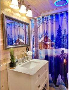 a bathroom with a sink and a shower curtain at Charming vacation nest in Sevierville