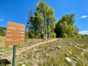 a sign on a dirt road in a field at Frey Gulch 46 by SummitCove Lodging in Colorado in Keystone