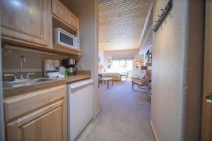 a kitchen with a sink and a microwave at Gateway Lodge 5054 by SummitCove Lodging in Colorado in Keystone