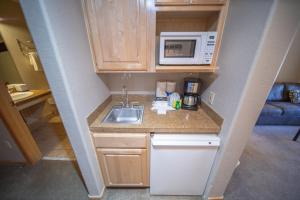a small kitchen with a sink and a microwave at Gateway Lodge 5054 by SummitCove Lodging in Colorado in Keystone