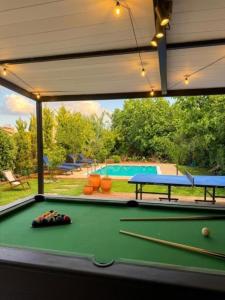 a pool table with a view of a swimming pool at Villa Hermes in Potamós