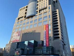 a tall building with signs on the side of it at Hachioji House 102 Apartment in Hachioji
