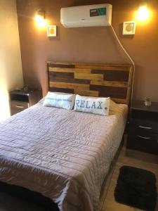 a bedroom with a large bed with a white bedspread at Complejo Renacer in Villa Parque Siquiman +72 photos