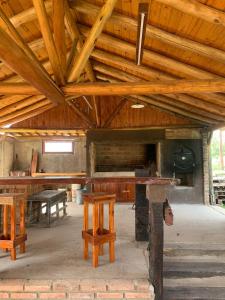 a room with wooden ceilings and tables and benches at Complejo Renacer in Villa Parque Siquiman